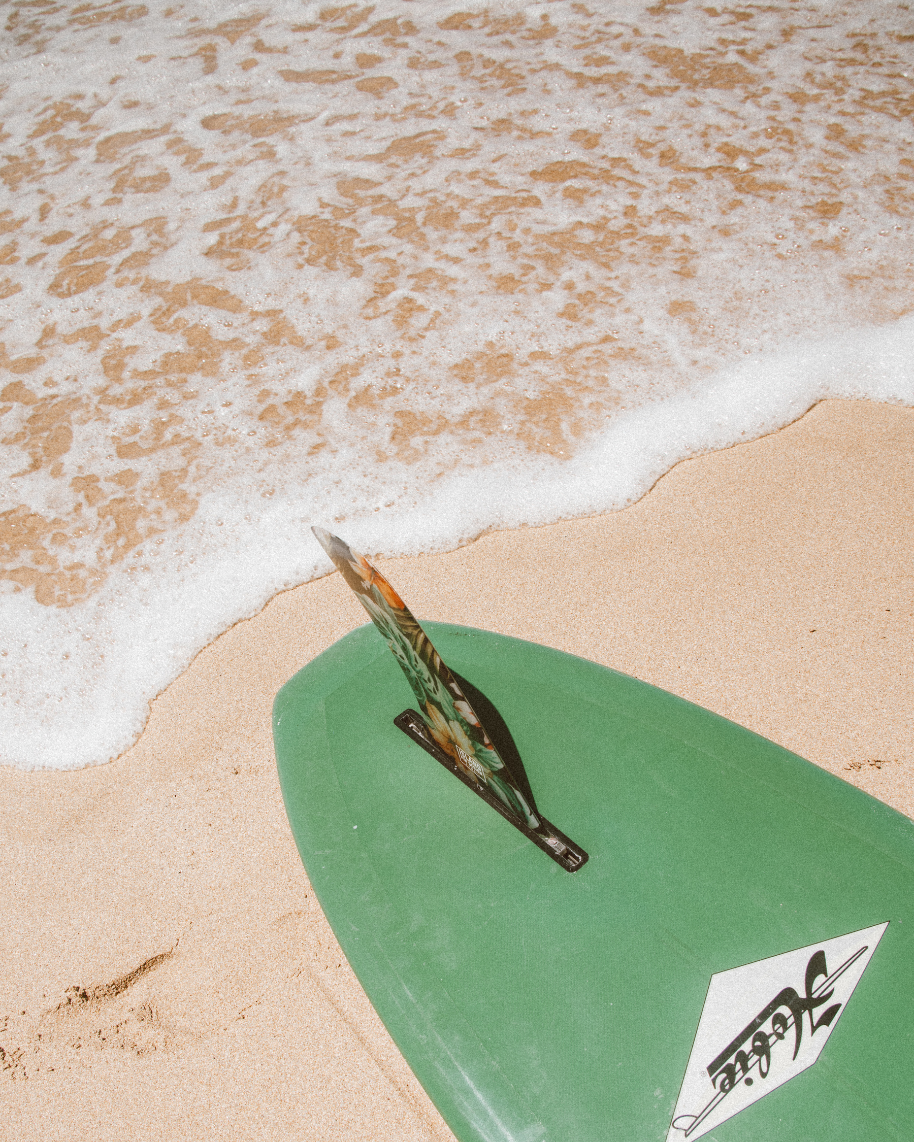 Green Surfboard on Beach Shore